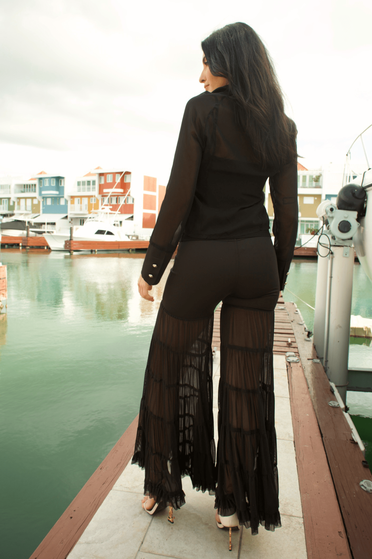 Back view of women's scuba tiered mesh pants, featuring a flattering fit and sophisticated layered mesh detailing.