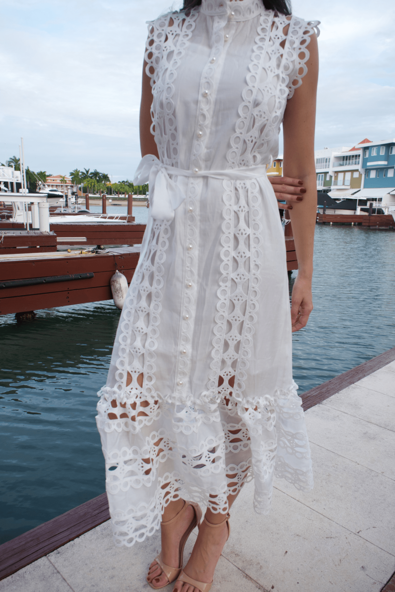 Close-up of a women's white maxi lace trim dress with a belt, highlighting the detailed lace trim and the adjustable belt for a perfectly cinched waist.