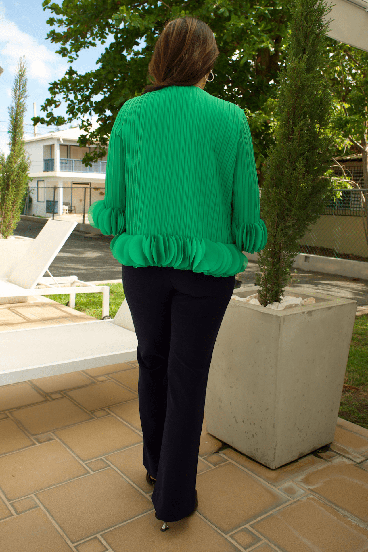 Back view of women's hunter green pleated top, featuring a flowy and chic design for any occasion.