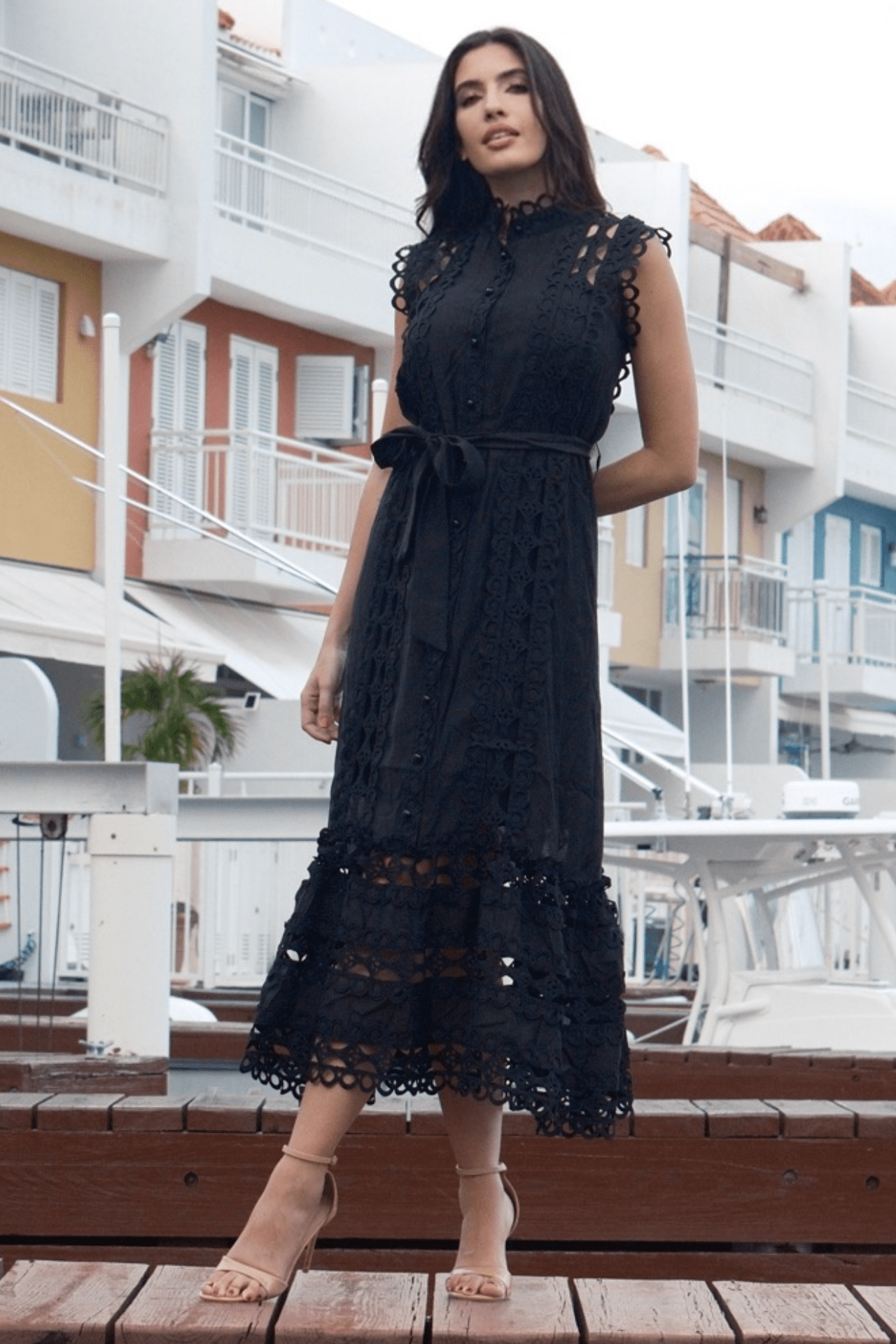 Front view of a women's  black maxi lace trim dress with a belt, featuring delicate lace detailing, a flattering belted waist, and an elegant length design.